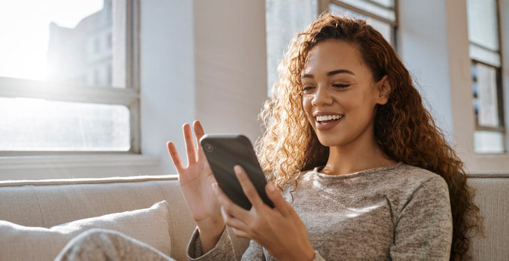 Sunshine young woman on phone smiling