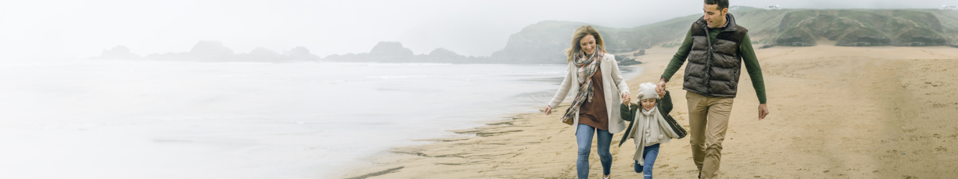 Young family walking on a beach