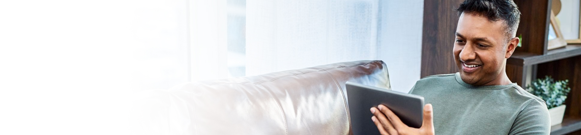 Men smiling looking at tablet